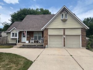 Before Exterior remodel on Overland Park home with khaki James Hardie Siding