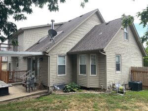 Before Exterior remodel on Overland Park home with khaki James Hardie Siding