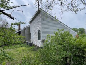 Before grey james hardie siding and provia window replacement on lee's summit home