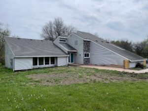 Before grey james hardie siding and provia window replacement on lee's summit home