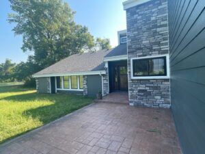 grey james hardie siding and provia window replacement on lee's summit home