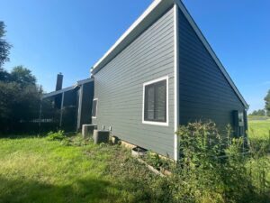 grey james hardie siding and provia window replacement on lee's summit home